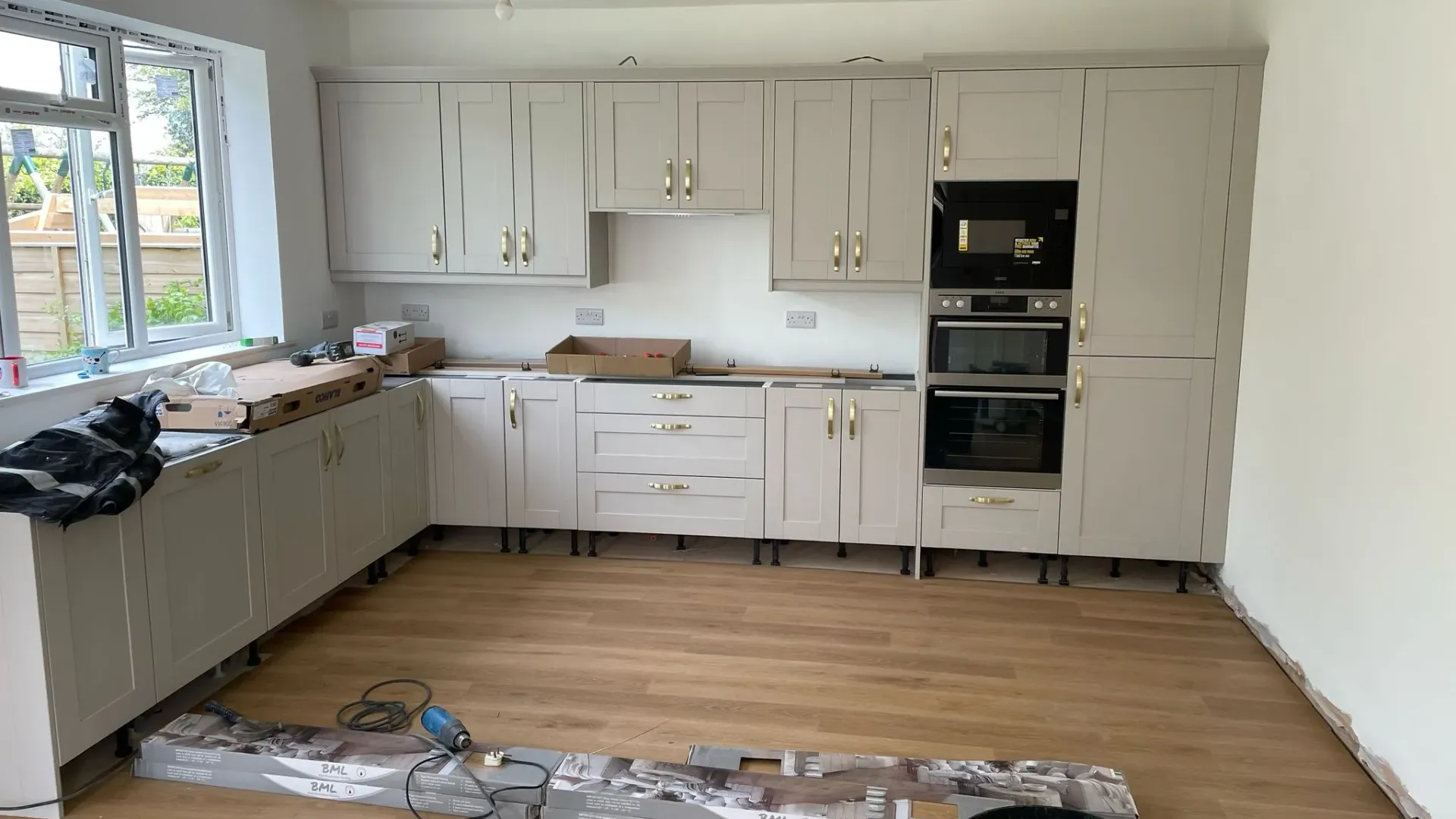 Kitchen installation in Hatherley by DP Carpentry & Building LTD - new cabinets and flooring.