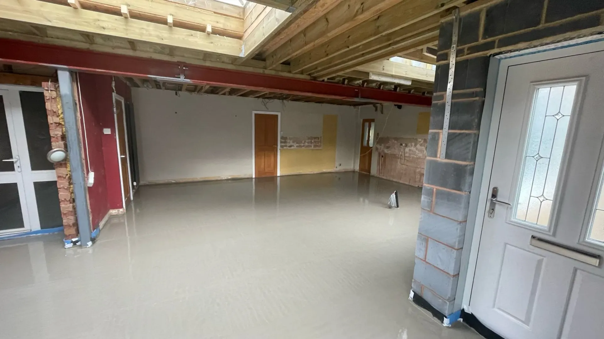 Freshly poured liquid screed floor in a Cheltenham home renovation project by DP Carpentry and Building LTD.