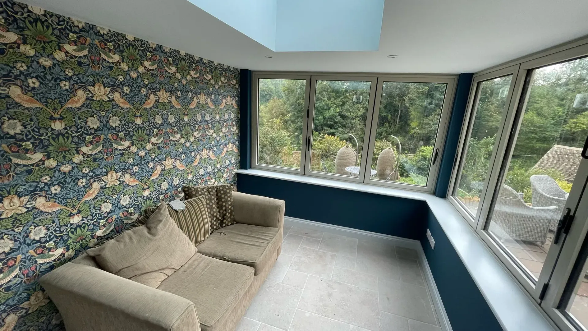 Completed orangery extension in Hatherley by DP Carpentry & Building LTD, featuring large windows and stylish interior.