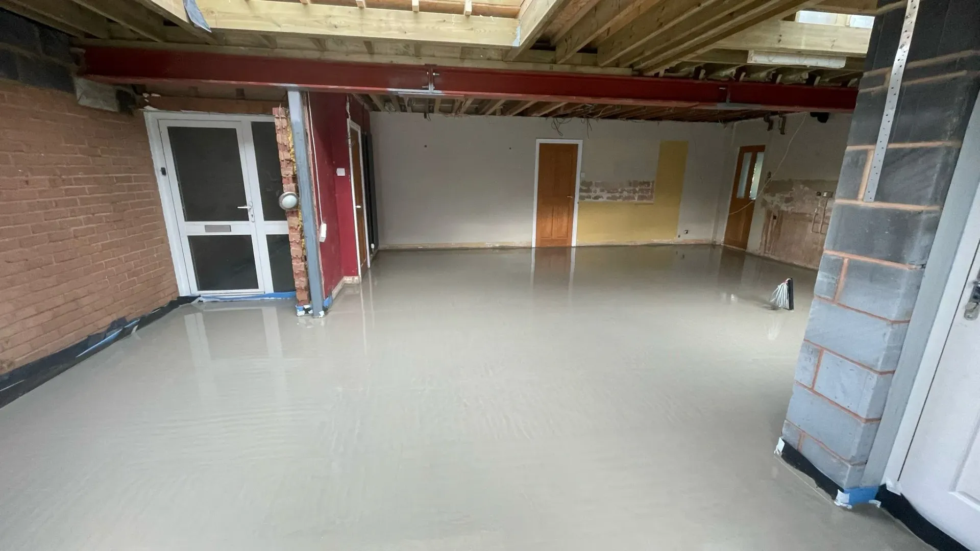 Liquid floor screed installation during a home renovation in Cheltenham.