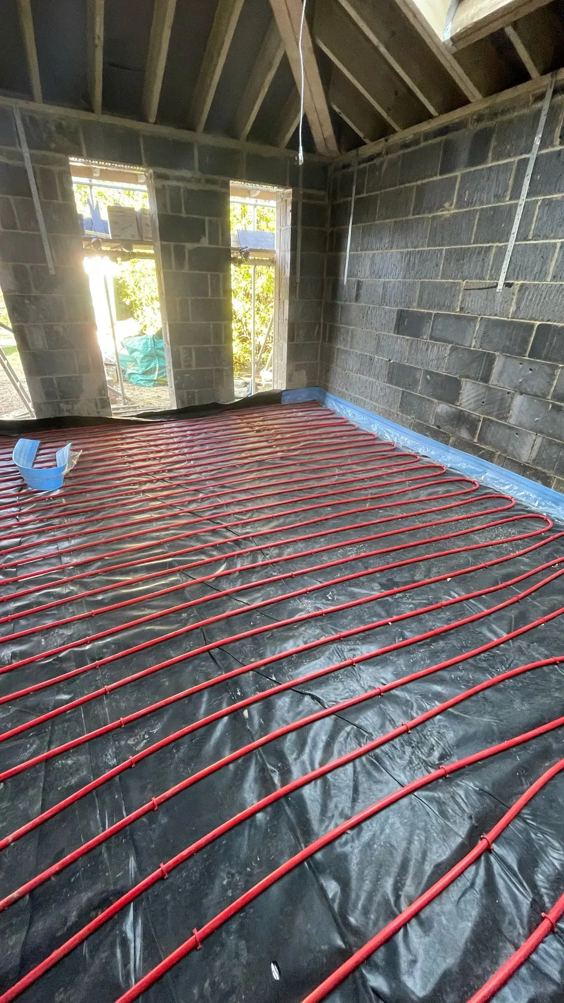 Underfloor heating pipe installation in a new building extension in Cheltenham