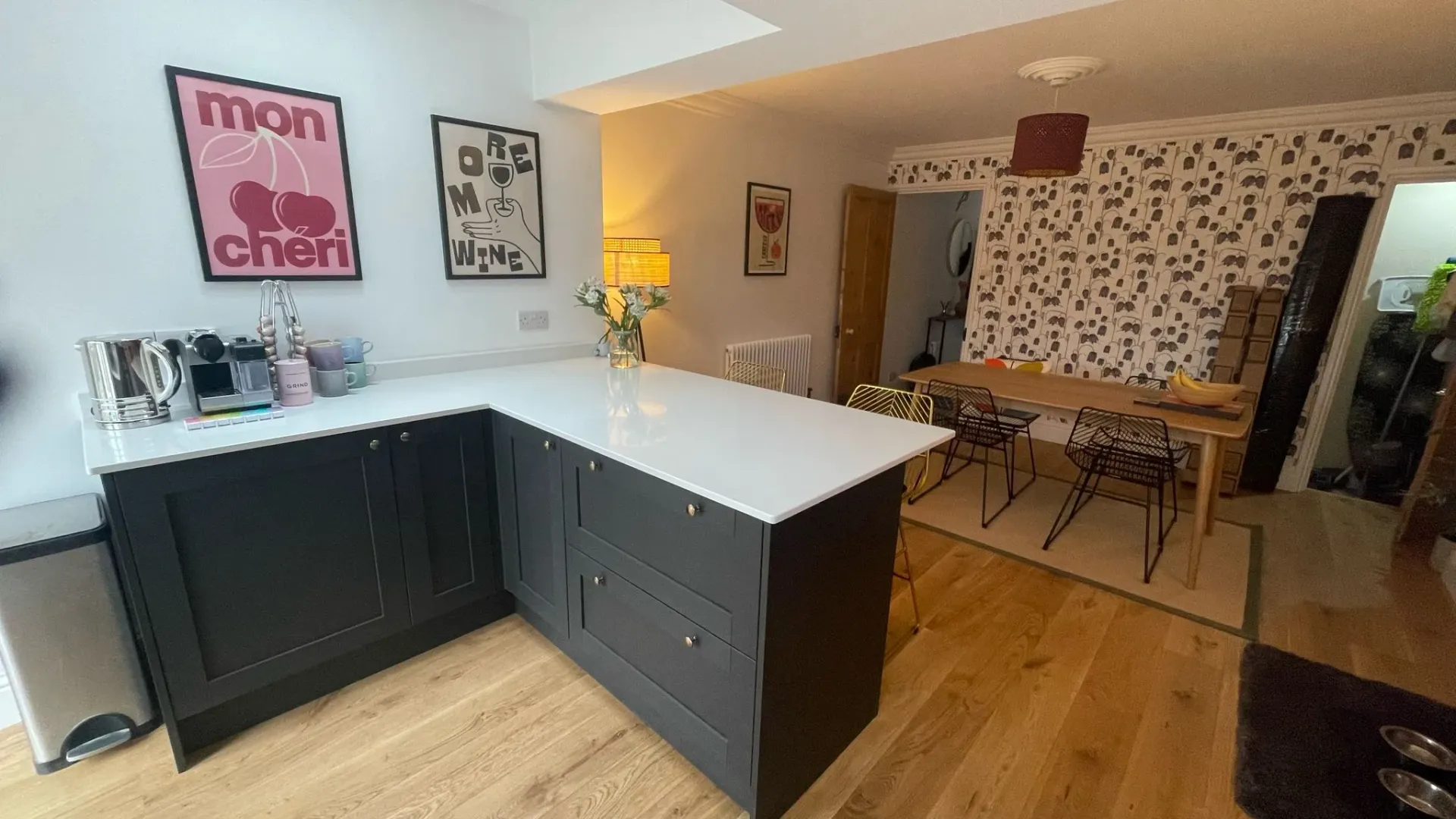 Modern bespoke kitchen installation by DP Carpentry & Building LTD in Cheltenham, showing dark cabinets and integrated dining space.
